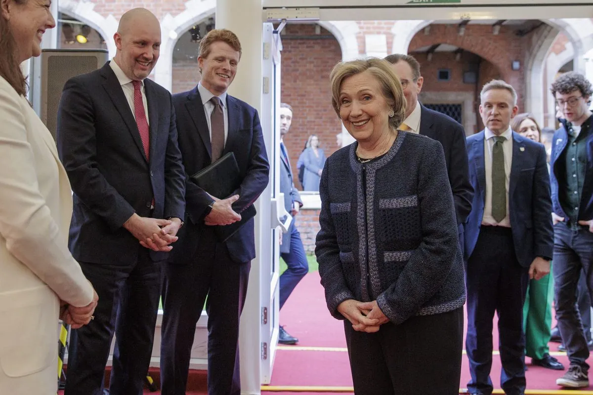 Police detain protesters during Hillary Clinton's Belfast university address